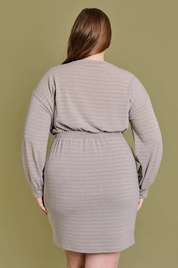 Back view of a plus size taupe stripe drawstring waist mini dress showing long sleeves and adjustable waist.