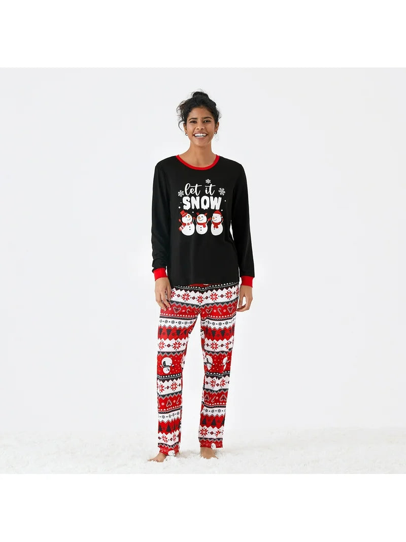 Woman wearing Let It Snow matching family Christmas pajamas, front view.