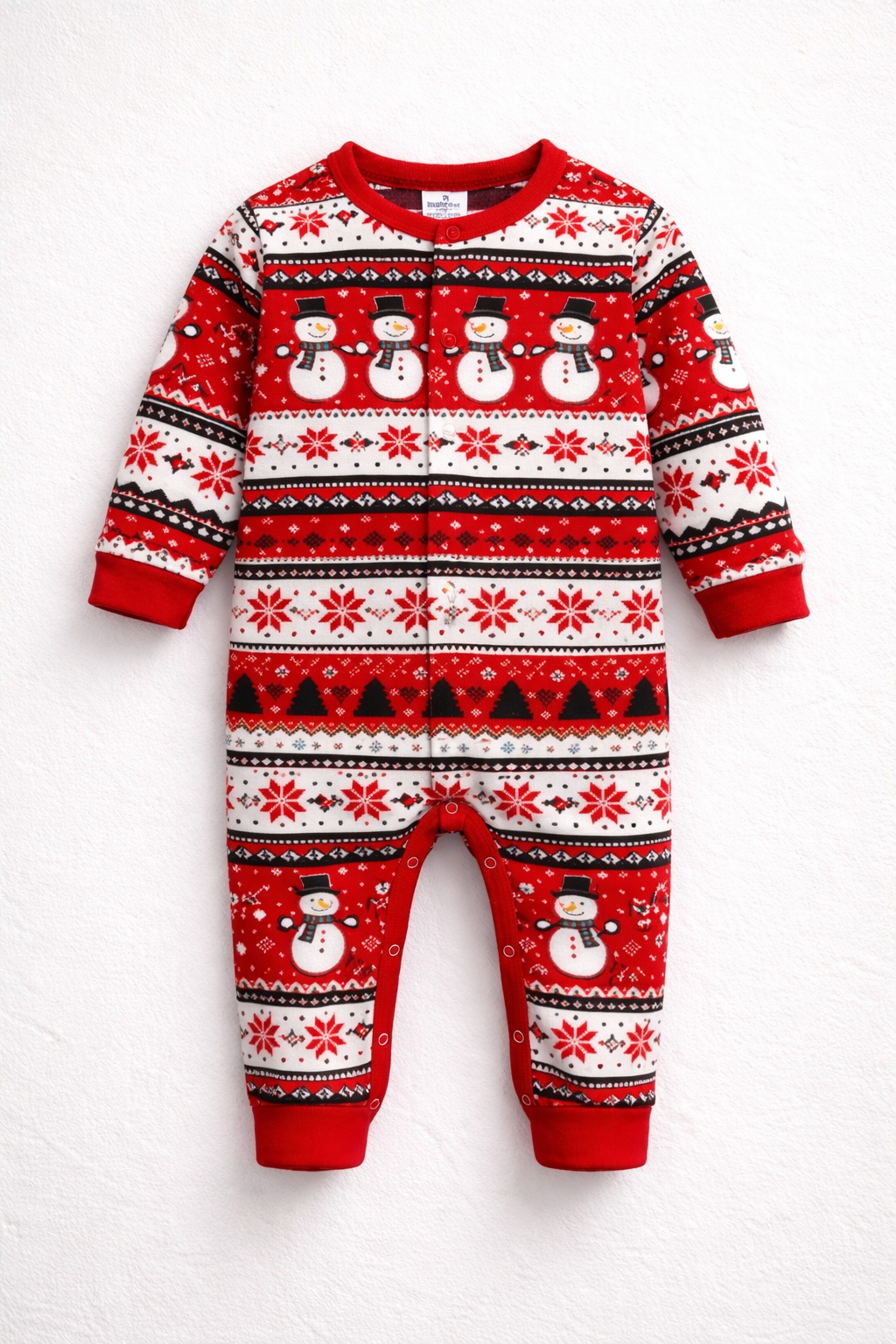 Baby wearing Let It Snow Christmas onesie with red snowflake pattern and open feet design.