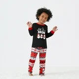 Child wearing Let It Snow kids Christmas pajamas with festive snowflake print and matching holiday pants.