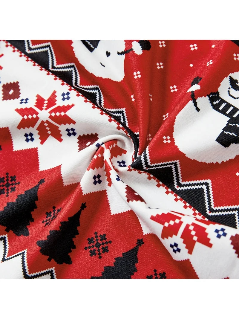 Close-up of red, white, and black snowflake fabric on Let It Snow kids Christmas pajamas.