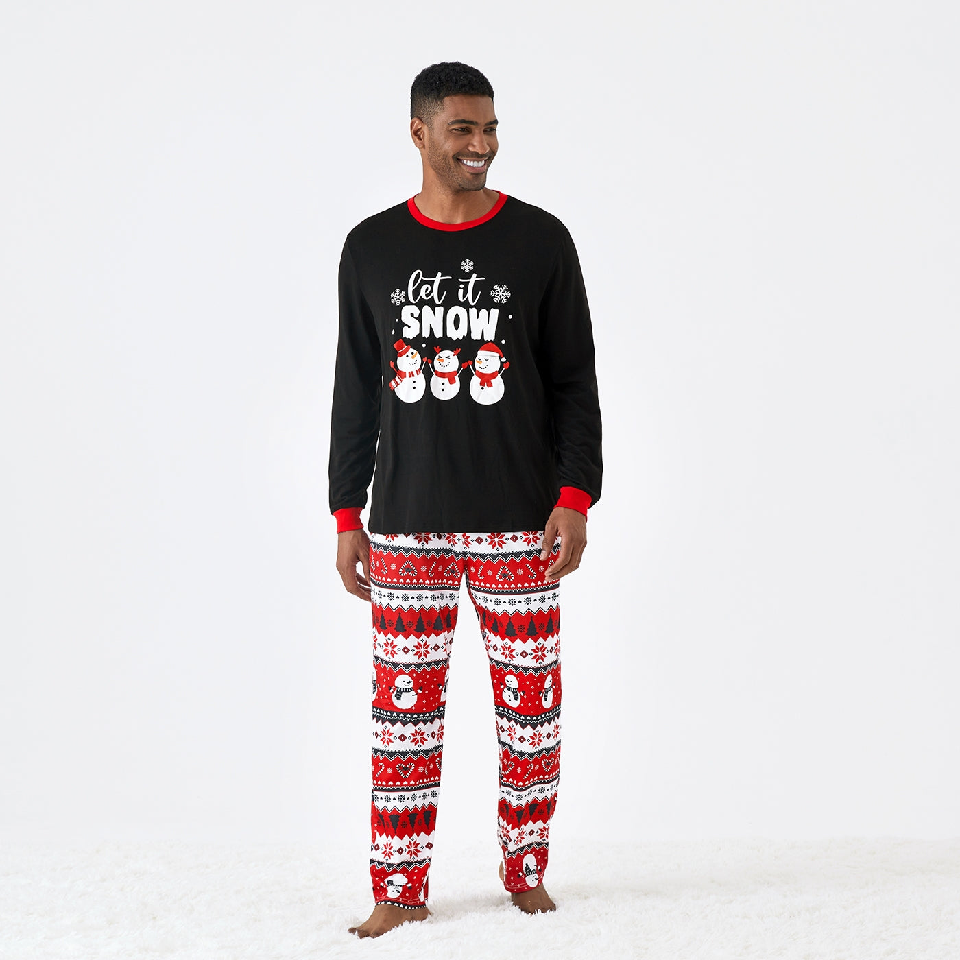 Man wearing Let It Snow men’s Christmas pajamas with snowflake print, front view.