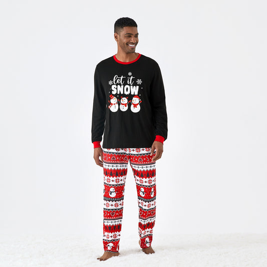 Man wearing Let It Snow men’s Christmas pajamas with snowflake print, front view.